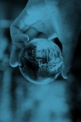 Image of hand holding a cricket ball, resembling the world in your hand